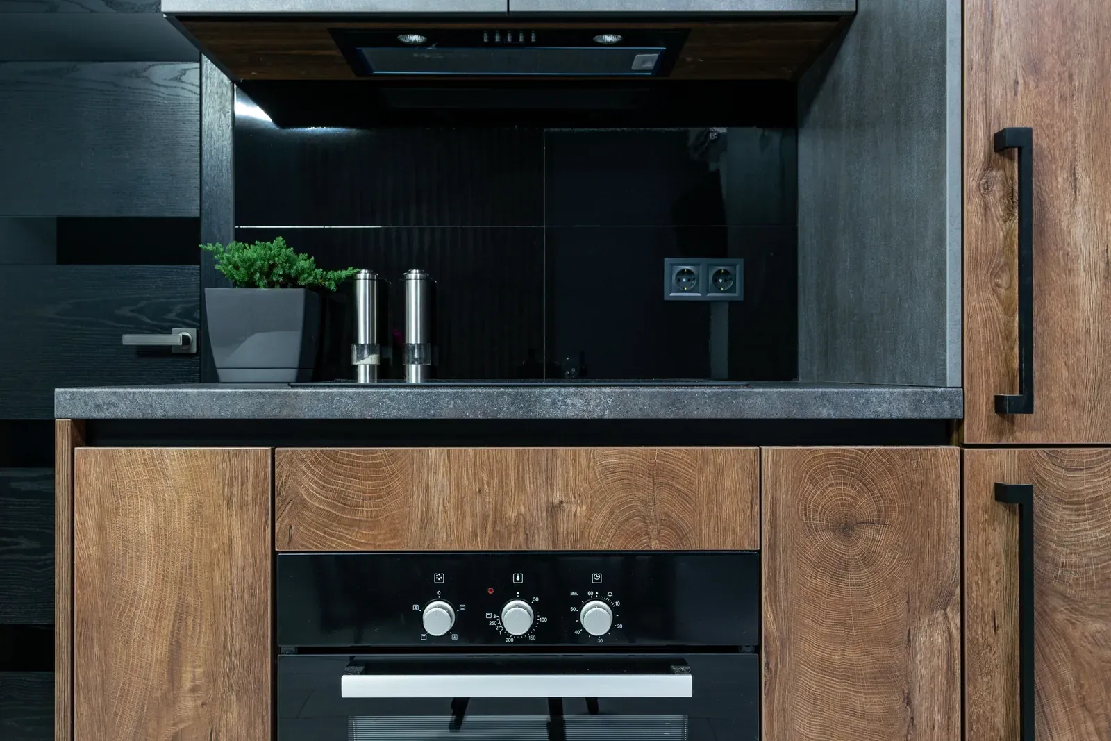 Wood-grain kitchen cabinets with black hardware