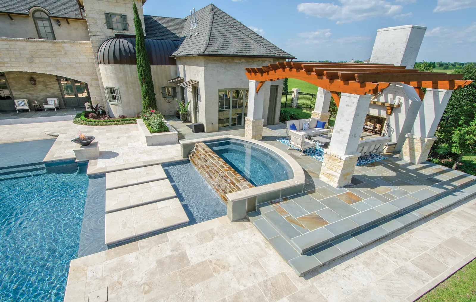Pool and spa surrounded by stone-look pavers