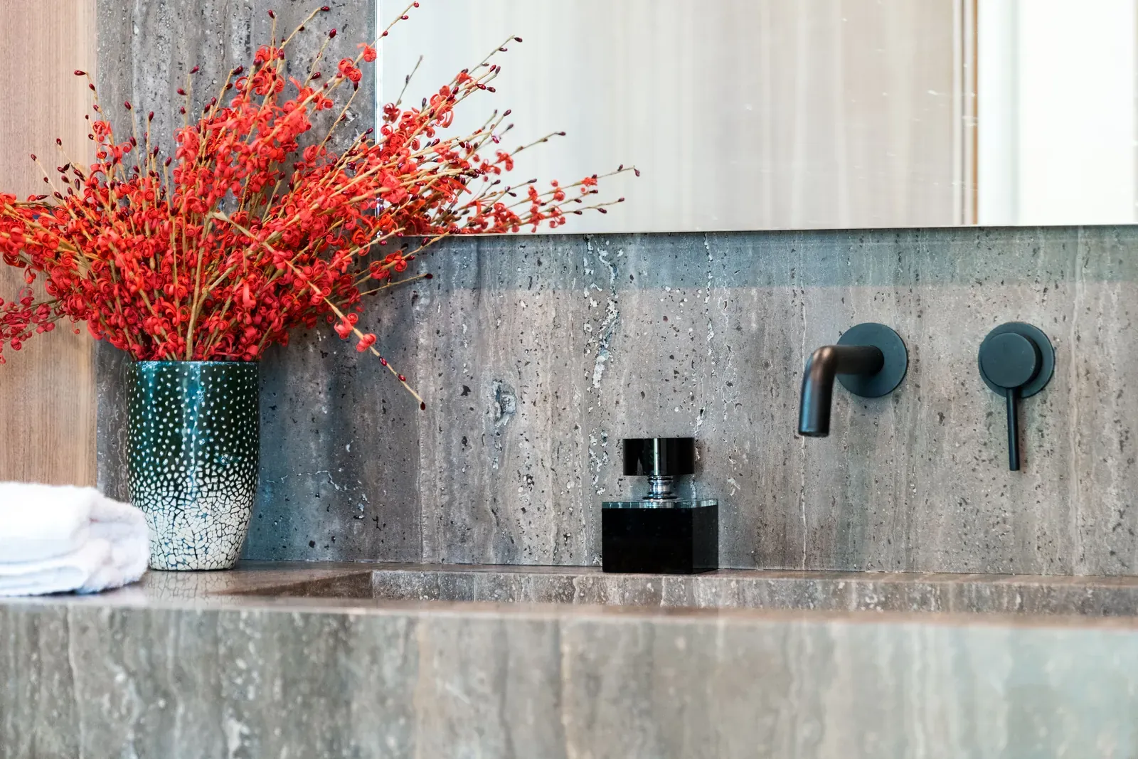 Stone-look porcelain vanity wall with black faucet