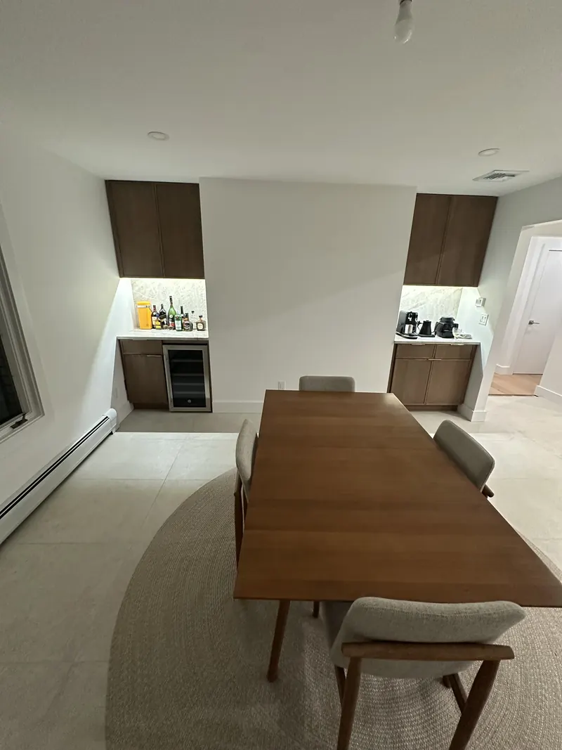 Dining room bar and coffee nooks in Ridgefield, NJ: Walnut cabinets, wine fridge cabinetry, quartzite backsplash