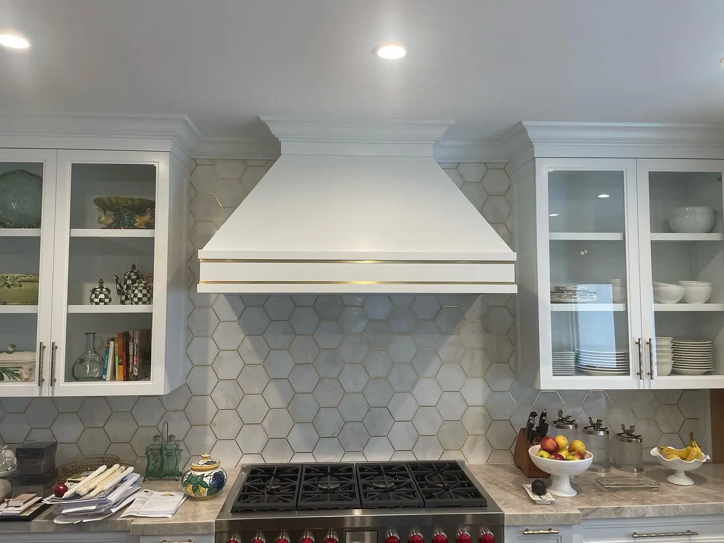 Kitchen backsplash tile behind a range with white hood