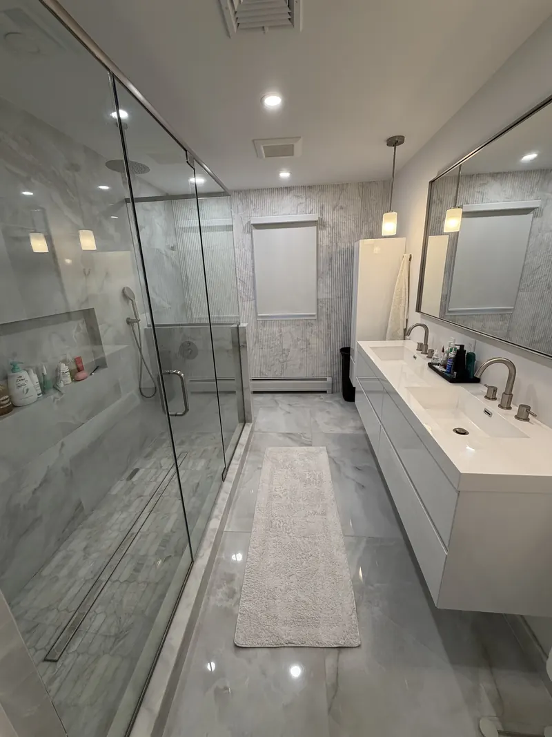 Marble-look bathroom in Fort Lee, NJ: Large marble-look porcelain tile, glass shower, floating vanity