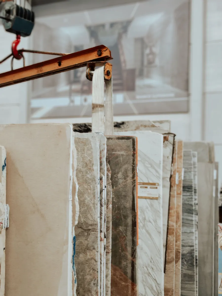 Natural stone slabs standing in a slab yard rack, each with its own veining