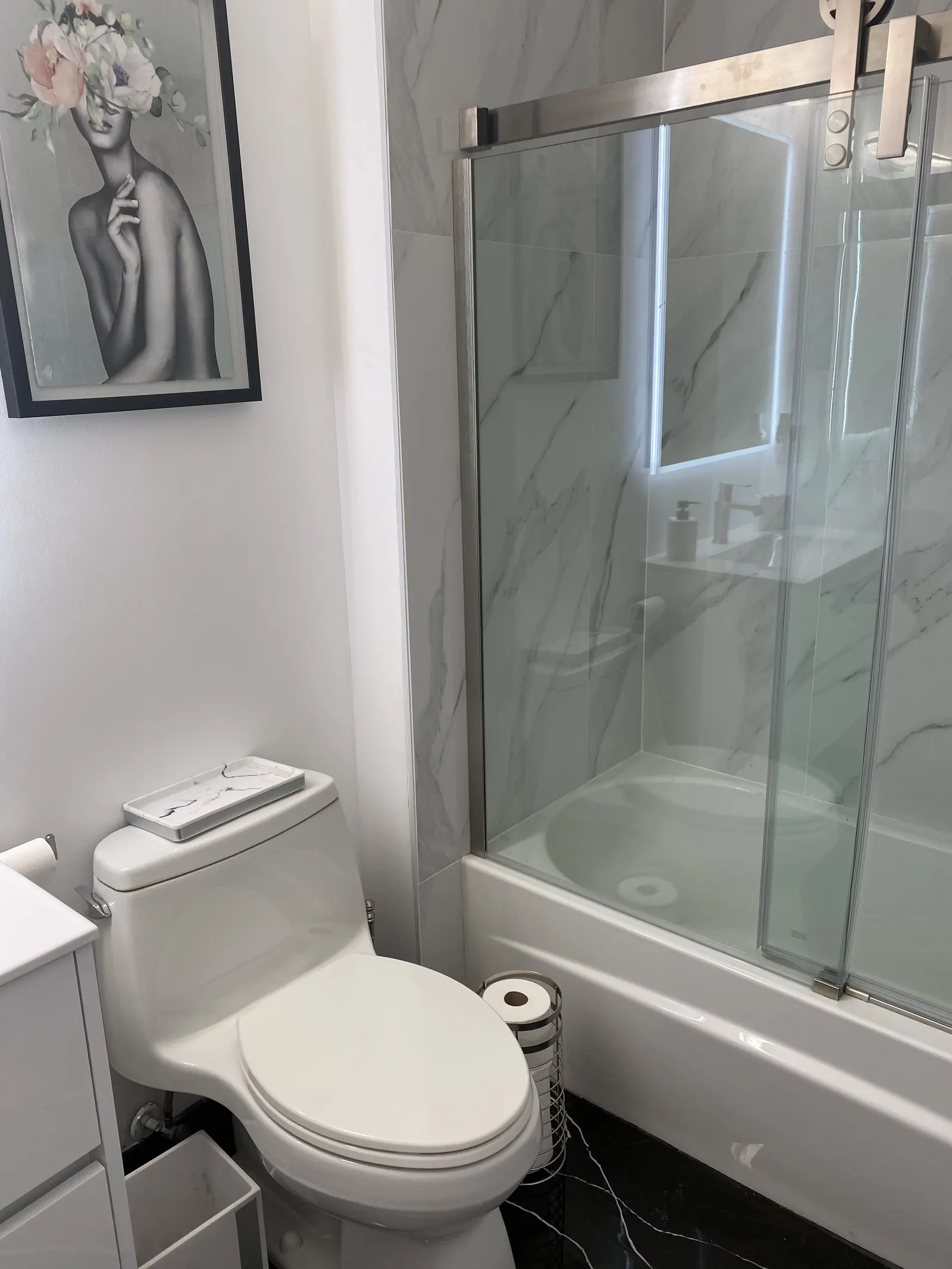 One-piece toilet beside a glass shower